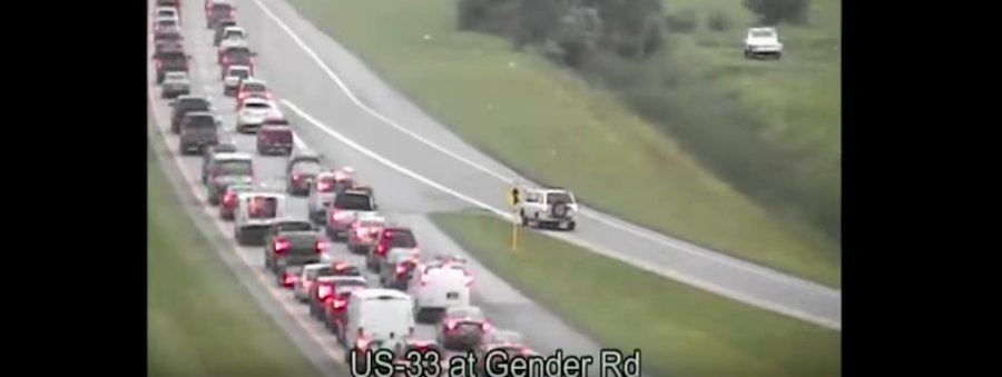 Watch a motorist reverse out of a traffic jam for more than a mile